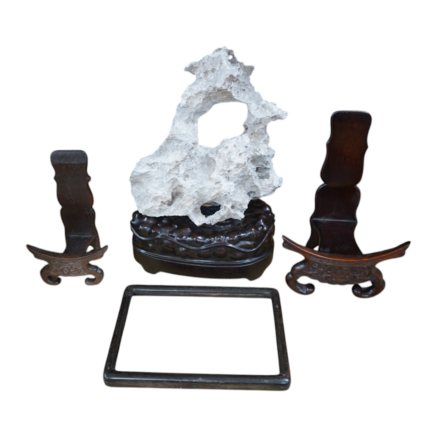 A Chinese grey stone scholar's rock, on stand, together with two Chinese hardwood plate stands and small hardwood frame, largest overall 38cm high. Condition - fair to good